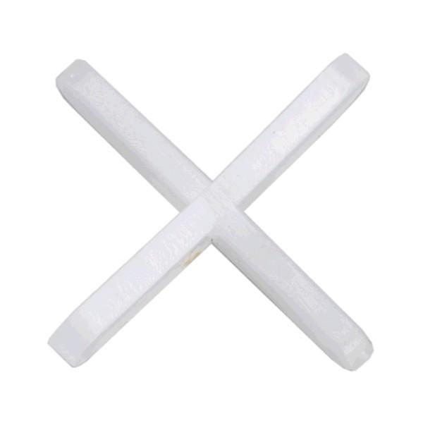 Close-up of a white cross tile spacer